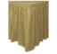 Lesklá plastová stolová sukně ve zlaté barvě, nařasená podél okraje stolu
