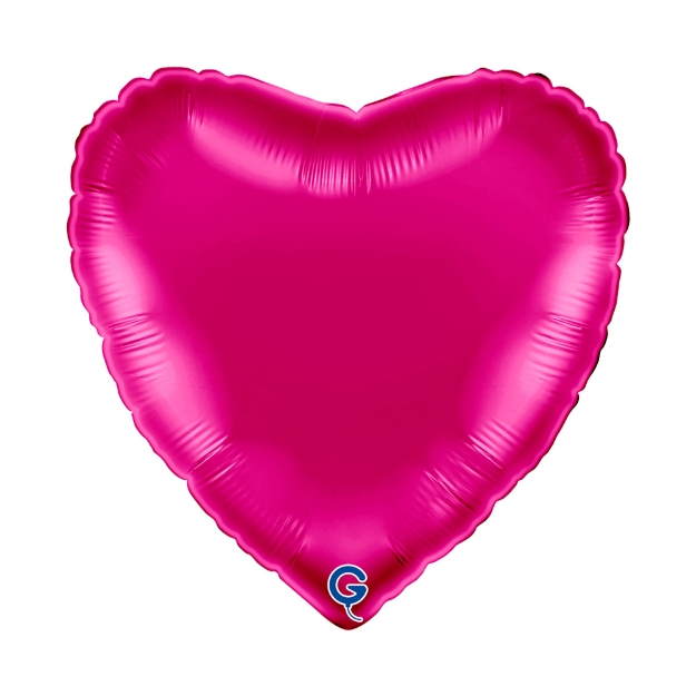 Tmavě růžový balonek ve tvaru srdce jako výrazná dekorace na oslavu nebo dívčí party