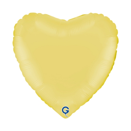 Matně žlutý balonek ve tvaru srdce jako svěží dekorace na dětskou nebo jarní oslavu